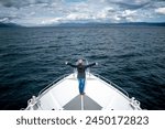 Tourist sailing through the Beagle Channel in Argentine Patagonia. Beautiful view of the Beagle Channel on the border between Argentina and Chile. Person facing the immensity of the Beagle Channel