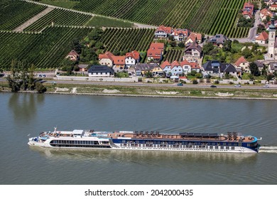 Tourist ship on Danube river against Durnstein village in Wachau valley, Unesco world heritage site in Lower Austria, Austria