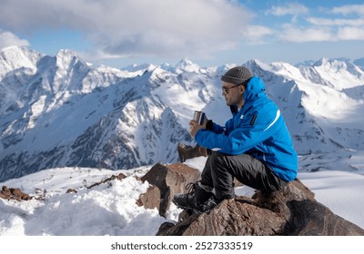 Tourist sits and rests while climbing in winter mountains - Powered by Shutterstock