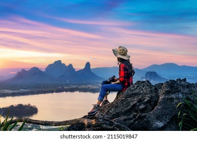 Tourist sitting on Phu sub lek viewpoint at sunset, Lopburi, Thailand. - Shutterstock ID 2115019847