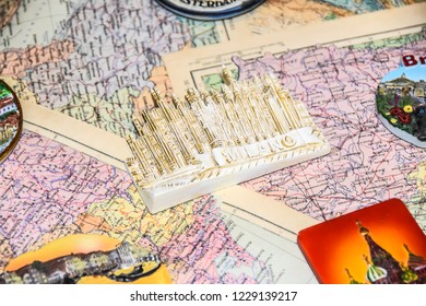 a lot of tourist souvenirs of magnets from different countries on the map designer background bright - Shutterstock ID 1229139217