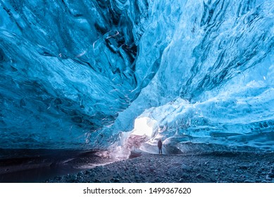 Tourist Standing In An Ice Cave In Vatnajökull Glacier Iceland