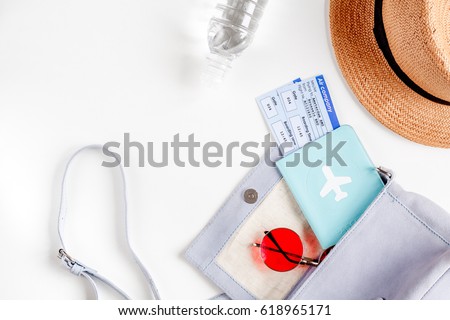 tourist stuff with passport and hat on white background top view
