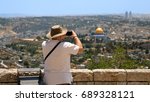 Tourist takes a photo of Jerusalem Old City view. Mount Scopus is a famous Holy Land place and it has a fantastic view to the Old Jerusalem. Jerusalem is a beautiful and popular touristic city.