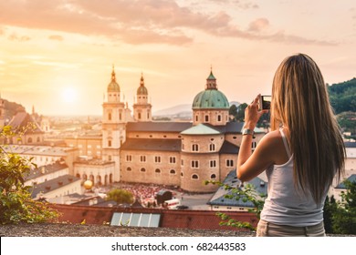 Tourist taking a photo with mobile of beautiful sunset in Salzburg Austria