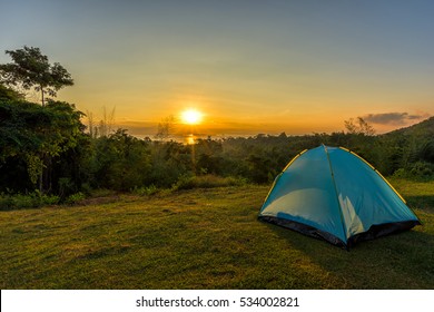 Tourist Tent In Camp Among Meadow In The Mountain At Sunrise