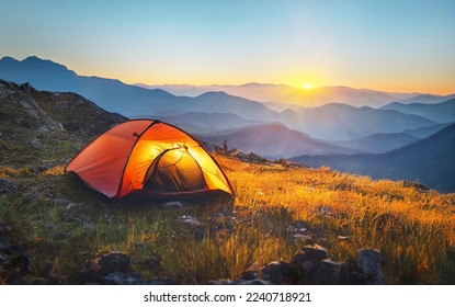 tourist tent camping in mountains at sunset - Powered by Shutterstock