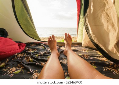Tourist tent inside with women's feet