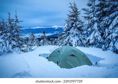 Tourist tent in the snow after blizzard snowstorm in the Carpathian mountains - Powered by Shutterstock