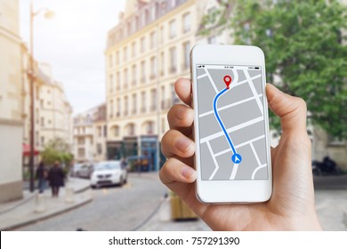 Tourist using GPS map navigation app on smartphone screen to get direction to destination address in the city streets, travel and technology - Shutterstock ID 757291390