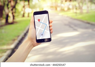 Tourist using navigation app on the mobile phone. Freedom and active lifestyle concept - Powered by Shutterstock