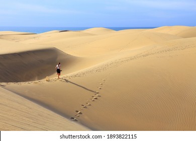 Tourist Visits Gran Canaria Dunes - Maspalomas Sand Desert Landscape.