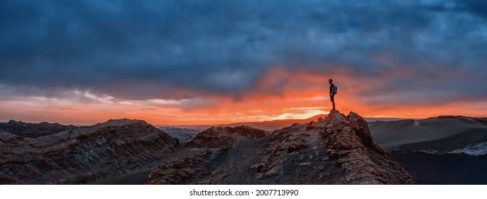 Tourist watching the sunset at the Valle de la Luna, Atacama desert, Chile