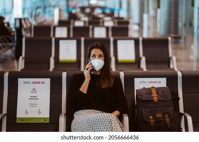 Tourist Woman At The Airport Waiting For Her Flight. Wearing A Mask For Covid 19 Protection Making A Call While Waiting. Lifestyle. Travel