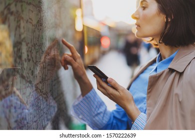 Tourist Woman Checking The Route On Interactive Kiosk With Public Transport Subway Map Outdoor At City Center