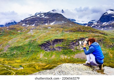 Tourist Woman Enjoy Mountains Landscape, Taking Travel Photo With Camera. National Tourist Scenic Route 55 Sognefjellet, Norway