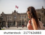 Tourist woman looking at the Cathedral of Lima in the main square, Peru in cloudy day