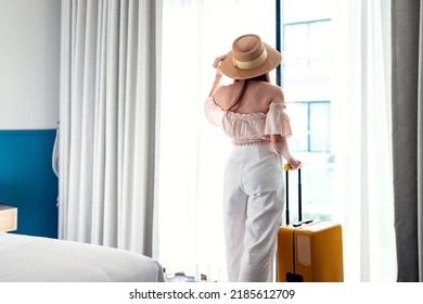Tourist Woman With Luggage In Hotel After Check-in. Conceptual Of Travel And Vacation.