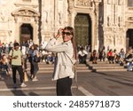 Tourist woman near Duomo di Milano cathedral church. Milan, Italy