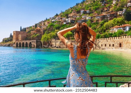 Tourist woman near Kizil Kule Red tower in Alanya, Antalya, Turkey