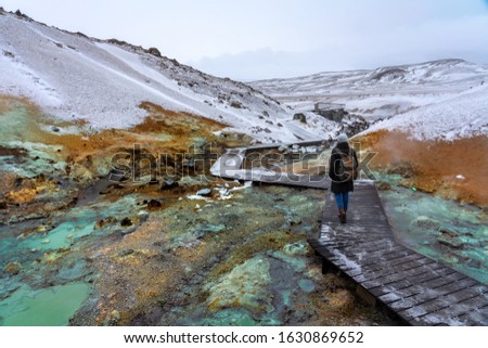 tourist woman on the path of colorful krysuvik seltun on reykjanes peninsula in Iceland
