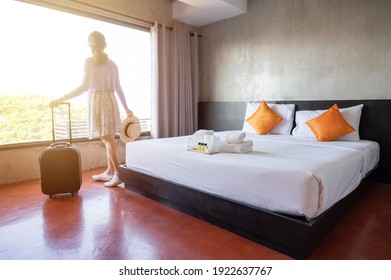 Tourist Woman Pulling Her Luggage In Hotel Bedroom After Check-in. Conceptual Of Travel And Vacation.