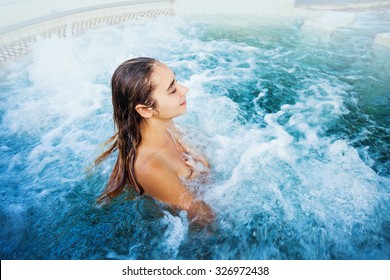 tourist woman relaxing in a thermal hotspring or jacuzzi bath