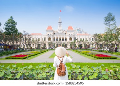 Tourist woman is sightseeing at famous landmark of Hochiminh City "People's of Committee of Hochiminh City" in Vietnam.