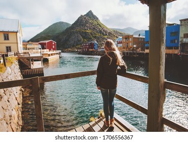 Tourist woman sightseeing Nyksund village in Norway travel lifestyle vacations outdoor scandinavian trip Vesteralen island