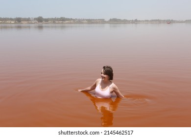 Tourist Woman Swimming. Lake Retba, Lac Rose, Senegal, Africa. Senegalese Landscape, Scenery. African Landmark. Nature, Lake Retba, Lac Rose In Senegal. Swim Woman. Tourism, Travel In Senegal, Africa