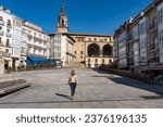 Tourist woman walking through the large Plaza de la Virgen Blanca in the city of Vitoria, Spain.