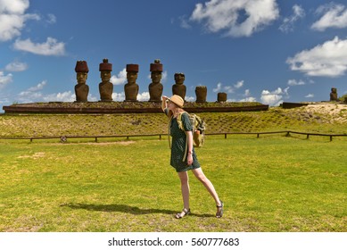 Tourist Young Woman With Bag On Anakena Beach With Moai Statues, Easter Island, Chile