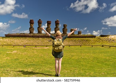 Tourist Young Woman With Bag On Anakena Beach With Moai Statues, Easter Island, Chile