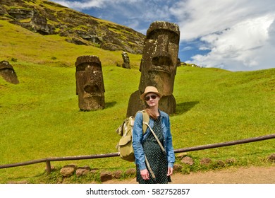 Tourist Young  Woman Near Moai Statues In The Rano Raraku Volcano In Easter Island, Chile