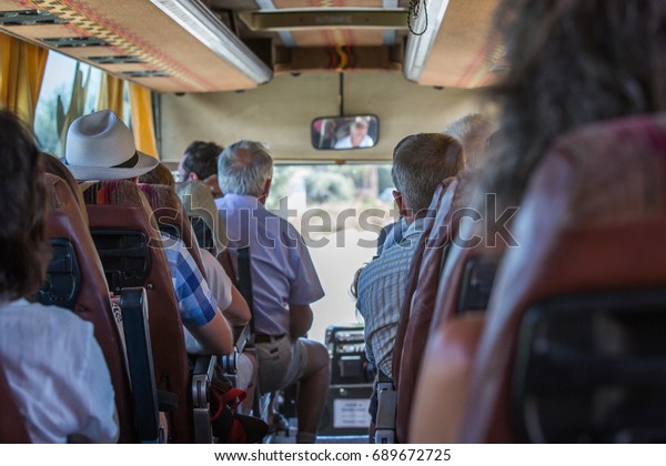 The touristic\
bus interior with people\
seating