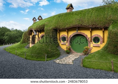 Touristic complex Boierul Ilie in Cisnadioara with unusual yellow house and green grass roof. Look like the hobbit's house. Transylvania, Romania
