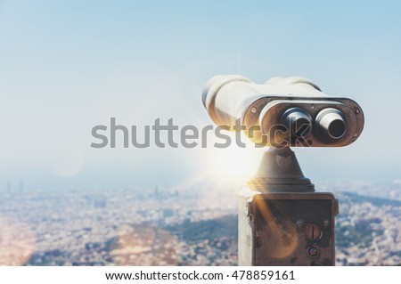 Touristic telescope look at the city Barcelona Spain, close up metal binoculars on background viewpoint overlooking the mountain, hipster coin operated in panorama observation blue sky, mockup flare