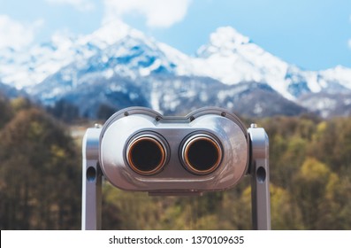 touristic telescope look at the city with view snow mountains, closeup binocular on background viewpoint observe vision, metal coin operated in panorama observation, travel nature concept - Shutterstock ID 1370109635