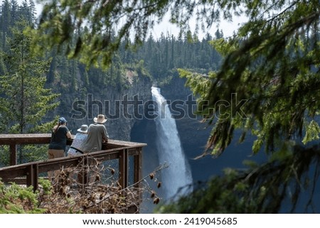 The tourists are admiring the Helmcken Falls, Clearwater, BC Canada from a viewpoint during summer time
