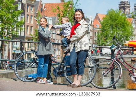 Tourists in Amsterdam. Mother with her kids walking in the streets of Amsterdam. The Netherlands
