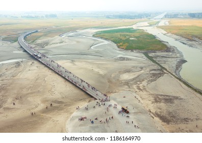 Tourists Arriving (walking,by Shuttle Bus, Or In Horse Carriage) To Visit The Famous Mont Saint Michel Abbey. France. Aerial View From The Walls Of Medieval Village. 