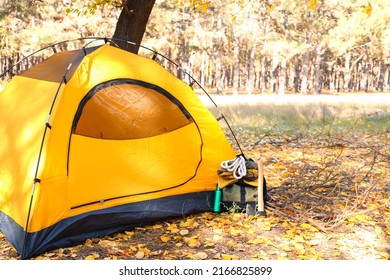 Tourist's backpack with survival kit near tent in forest - Shutterstock ID 2166825899