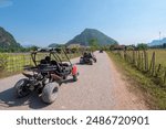 Tourists driving buggy ATV ride in Vang Vieng countryside, Laos