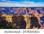 Tourists enjoy beautiful sunset above Grand Canyon National Park from Mather Point.