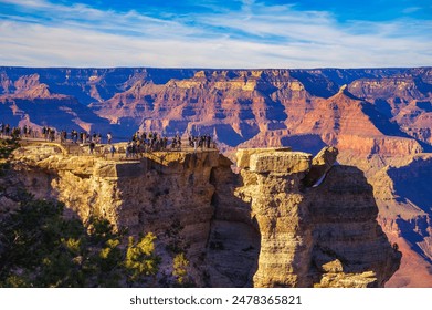 Tourists enjoy beautiful sunset above Grand Canyon National Park from Mather Point. - Powered by Shutterstock