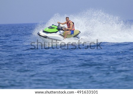 Tourists enjoy driving jetski on the ocean