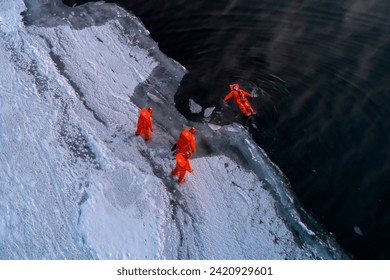 Tourists enjoy floating in dry survival suit in the middle of Arctic Sea.