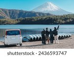 tourists enjoy with Fuji Mountain at Lake Saiko, happy friends group travel Mount Fuji and road trip Fuji Five Lakes. Landmark for tourists attraction. Japan Travel, Destination and Vacation concept