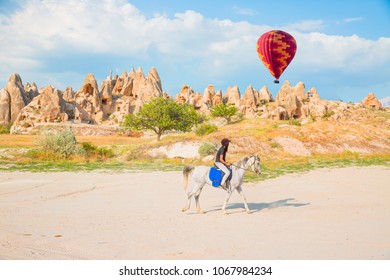 Tourists enjoy ride horses in Cappadocia