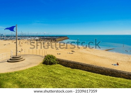 Tourists enjoy a sunbath on Plage de la Noëveillard by the Atlantic Ocean in Pornic, France